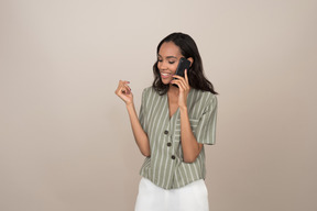 Pretty young girl talking on the phone and looking down