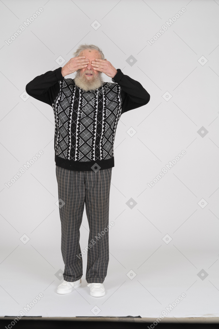 Old man covering eyes
