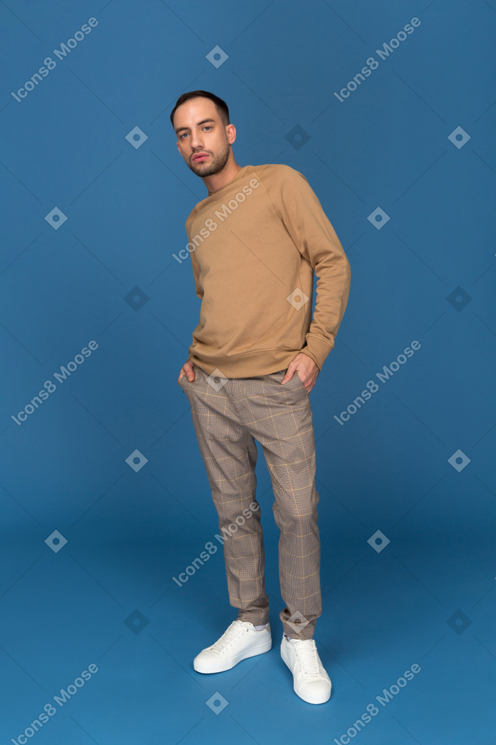 Young man with hands in pockets