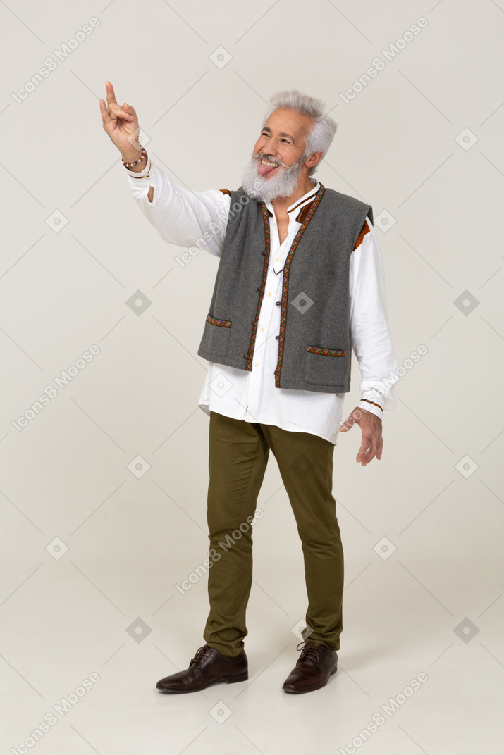 Man in gray vest making hand horns
