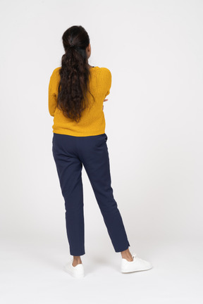 Back view of a thoughtful girl in casual clothes