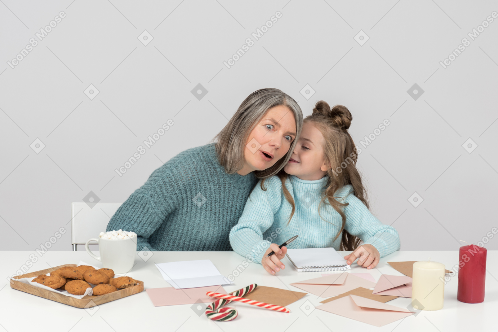 Grandmother and granddaughter writing a letter to santa together