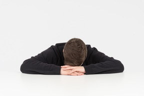 Exhausted office worker sleeping at his desk