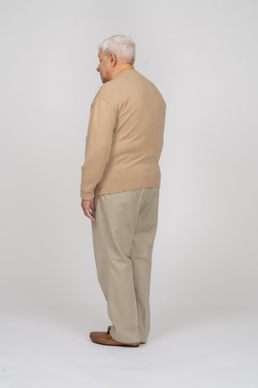 Side view of an old man un casual clothes standing still