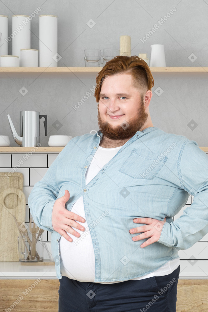 A fat man touching his belly and smiling
