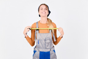 Female plumber holding ruler