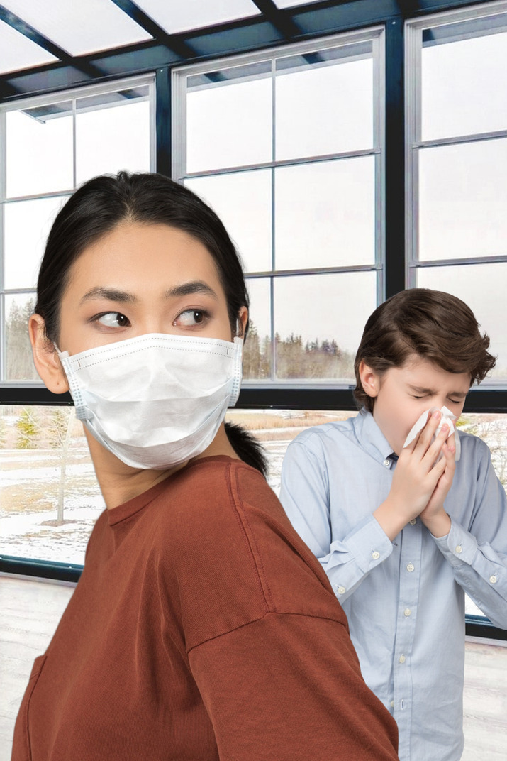 A woman wearing a surgical mask in an office