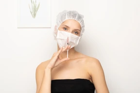 Woman in mask holding syringe