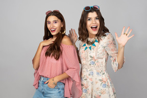 Excited looking girls dressed as for festival standing near each other