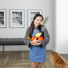 A woman standing in a room with a dog