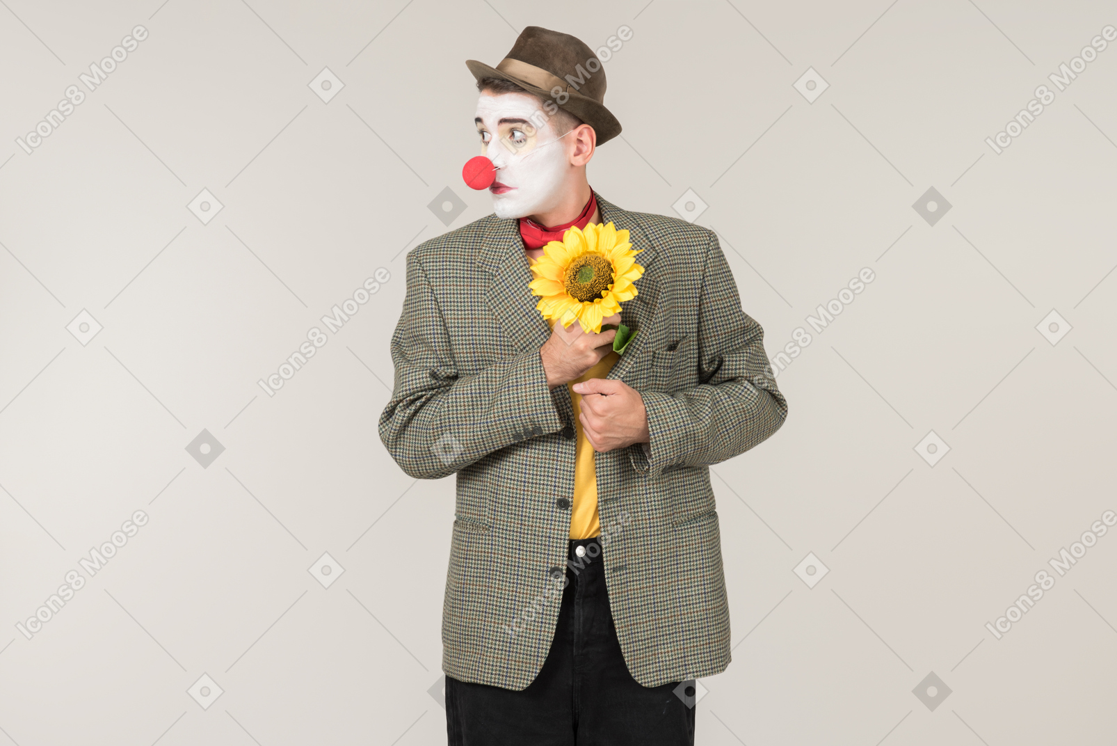 Male clown putting a sunflower out of the jacket