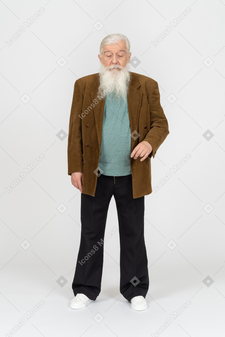 Old man looking down and raising hand