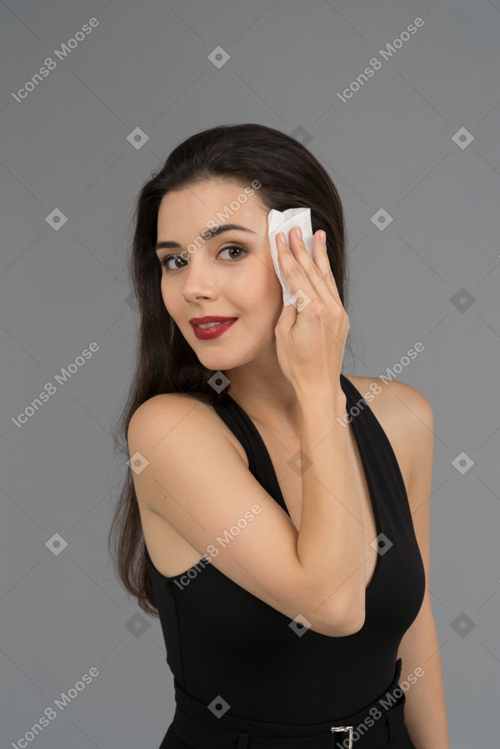 A cheerful woman wiping face