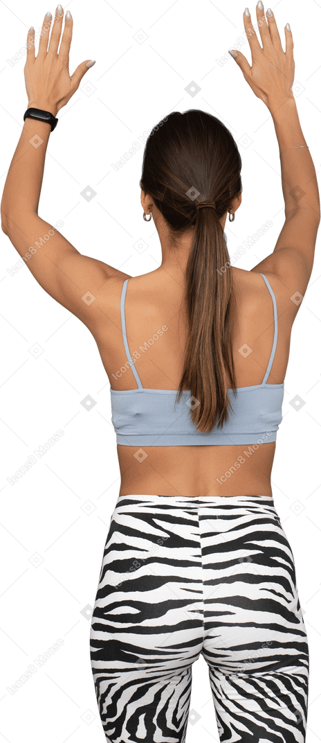 Back view of a female athlete raising her hands