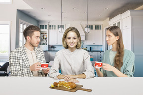 A group of people sitting around a kitchen table