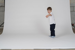 Side view of a boy reaching out his hand