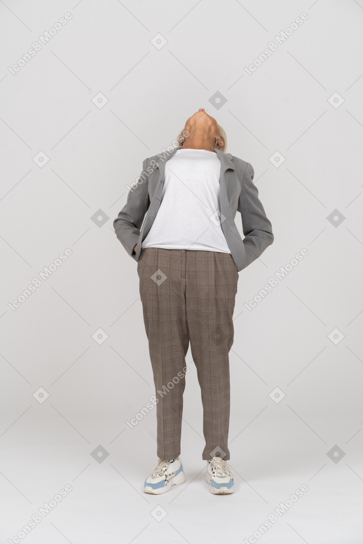 Front view of an old lady in suit leaning back