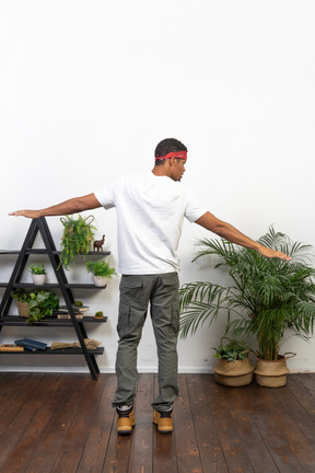 Good looking young man posing on the background of the apartment