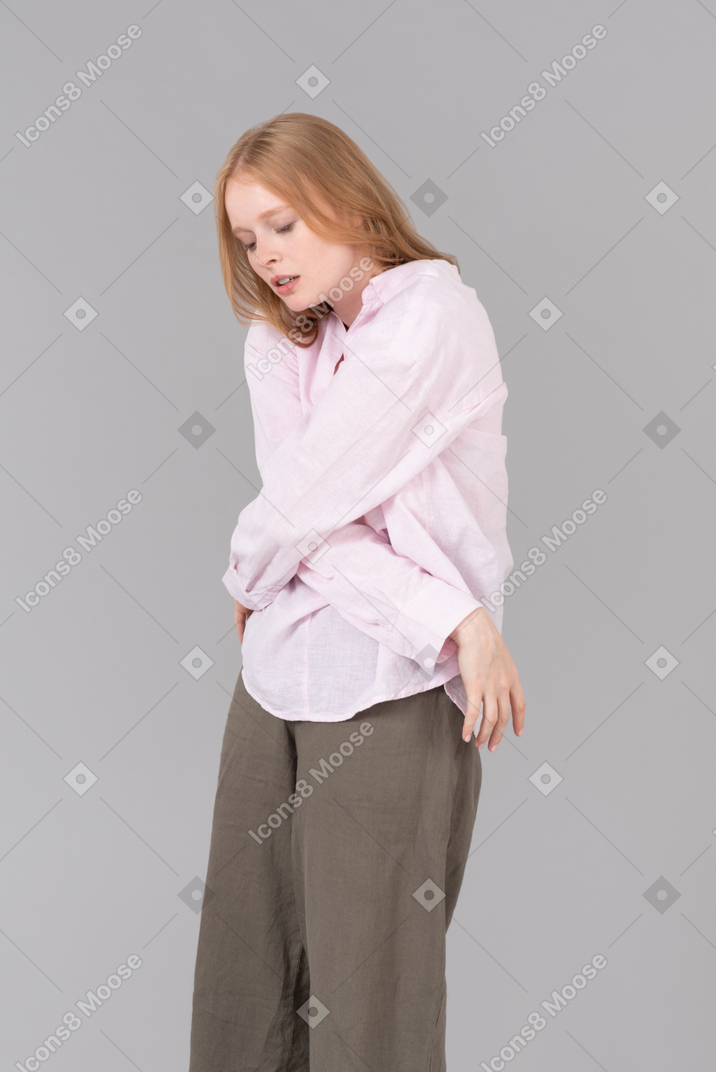 Young woman kind of touching herself with her hands crossed