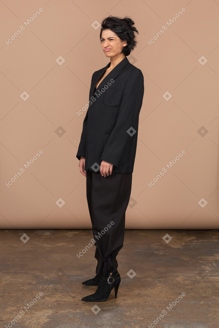Woman in suit and heels making faces