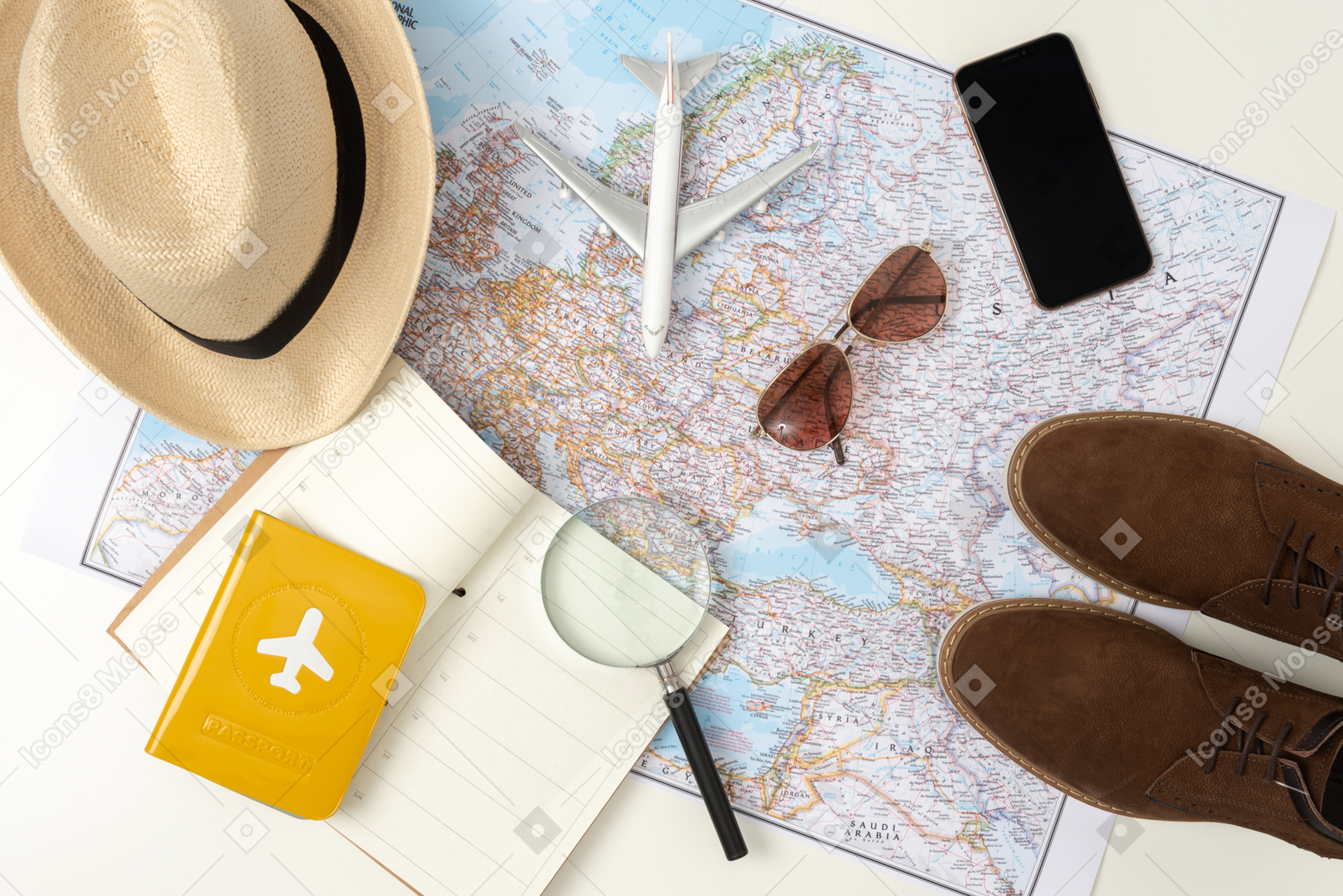 Your standard travel kit (don't forget the plain!), with the straw hat, comfortable boots, smartphone and sunglasses