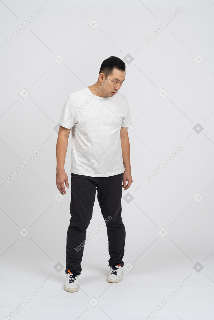 Front view of a confused man staring at something