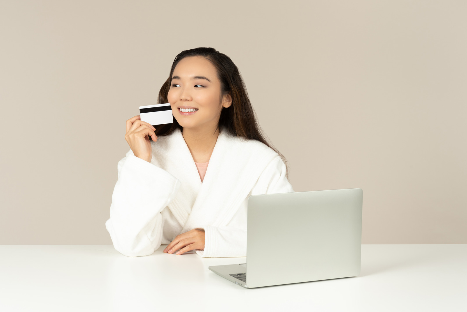 Smiling young asian woman doin online shopping