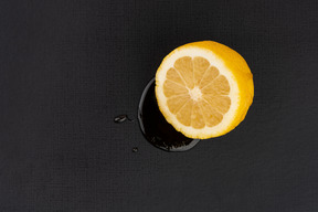 Squeezed orange on the black background