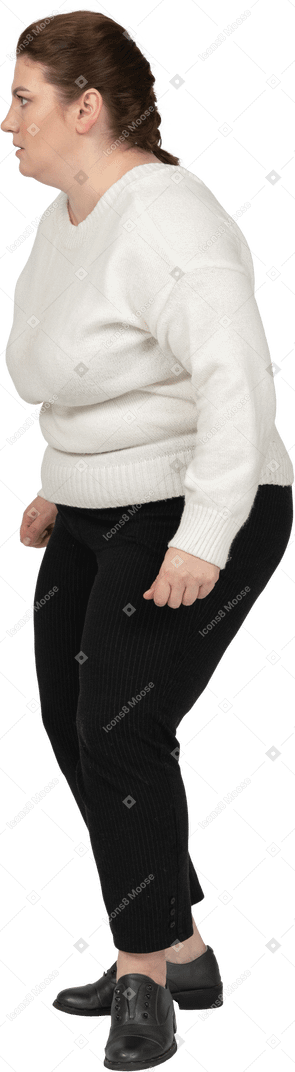 Scared plus size woman in casual clothes standing