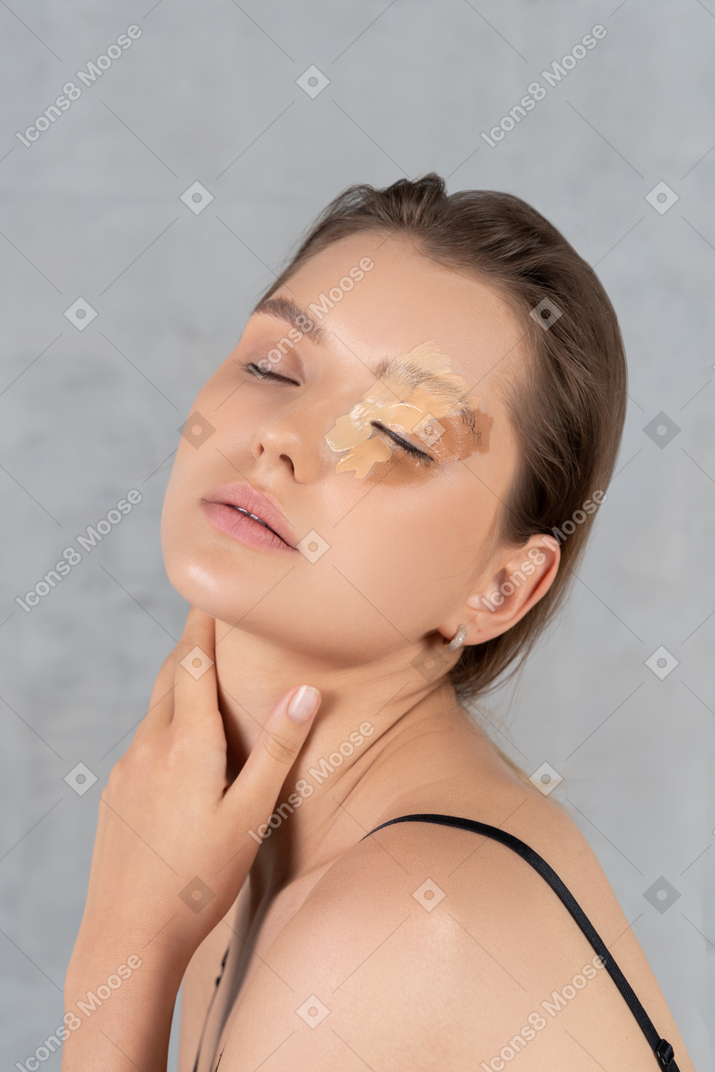 Close up of a young woman with different shades of foundation on her face