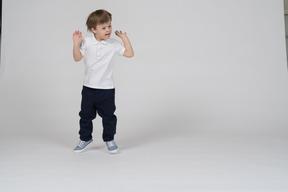 Front view of a boy jumping excitedly