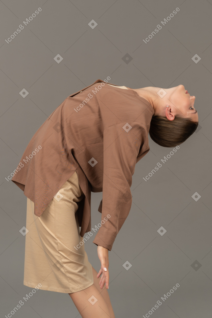 Young woman bending backwards