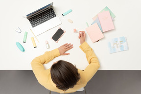 A female office worker doing her nails in the office