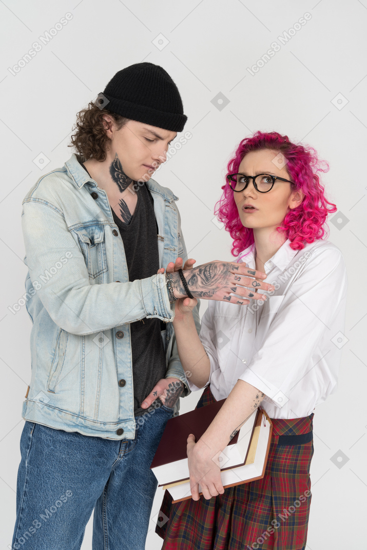 Uma jovem confusa usando óculos escuros tocando o pulso de sua amiga