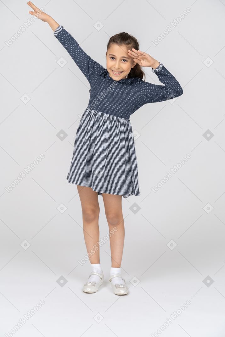 Front view of a girl saluting with a smile