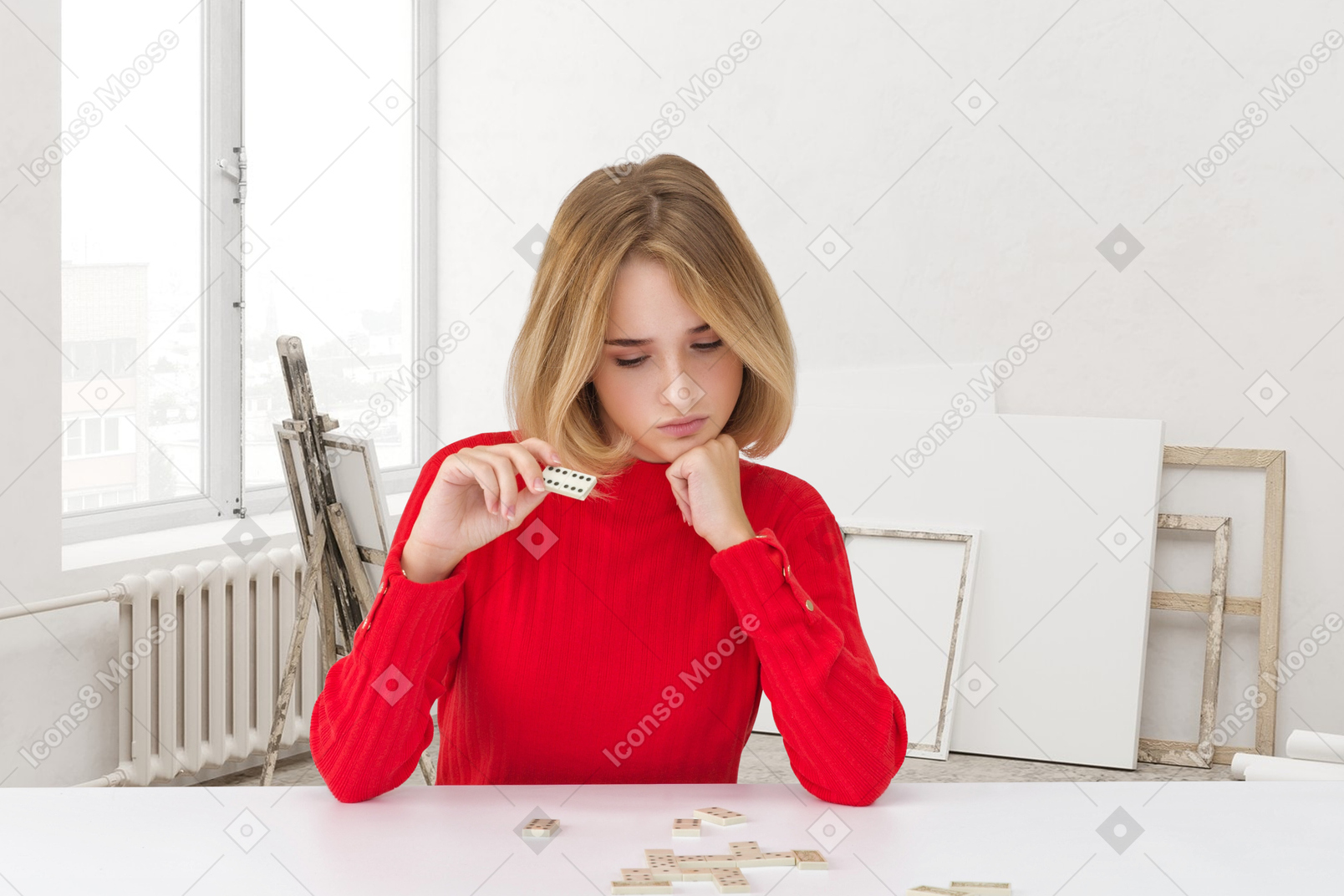 Pensive woman playing dominoes
