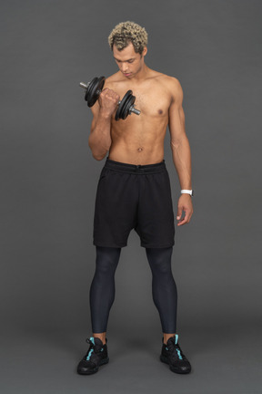 Athletic man working out with a dumbbell