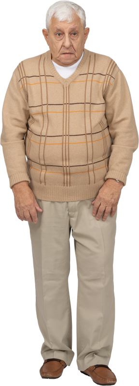 Front view of an impressed old man in casual clothes looking at camera