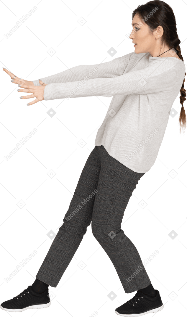 Brunette female bending backwards with outstretched arms making a stay away gesture