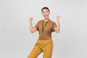 Young female pe teacher is excited and holding her hands up