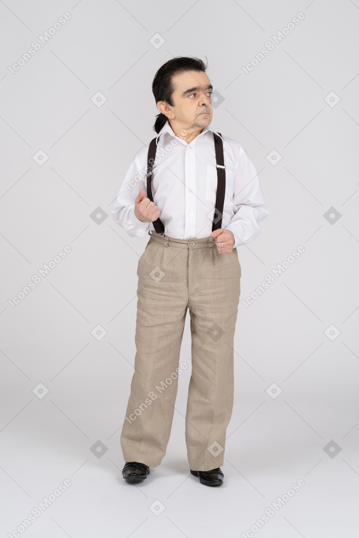 Middle-aged man holding his suspenders and looking away