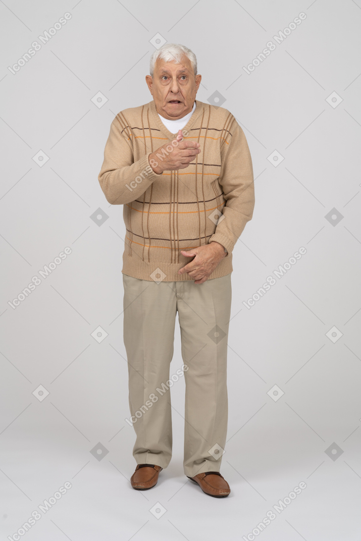 Front view of a scared old man in casual clothes