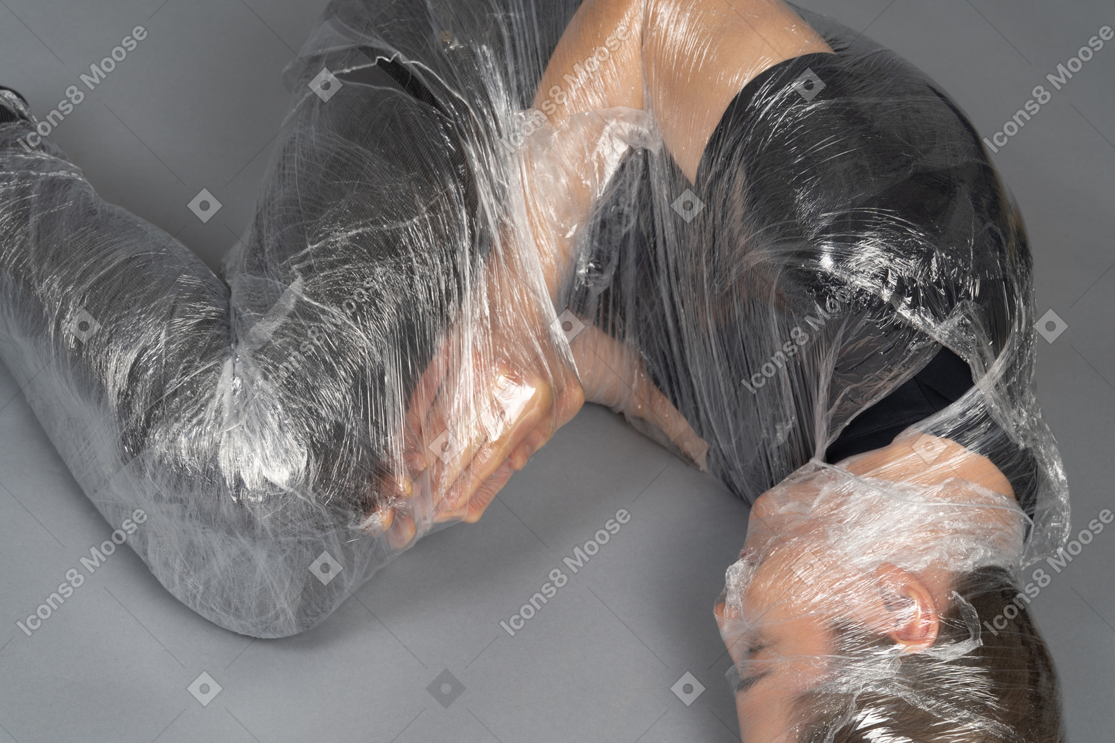 Close up of young man wrapped in plastic