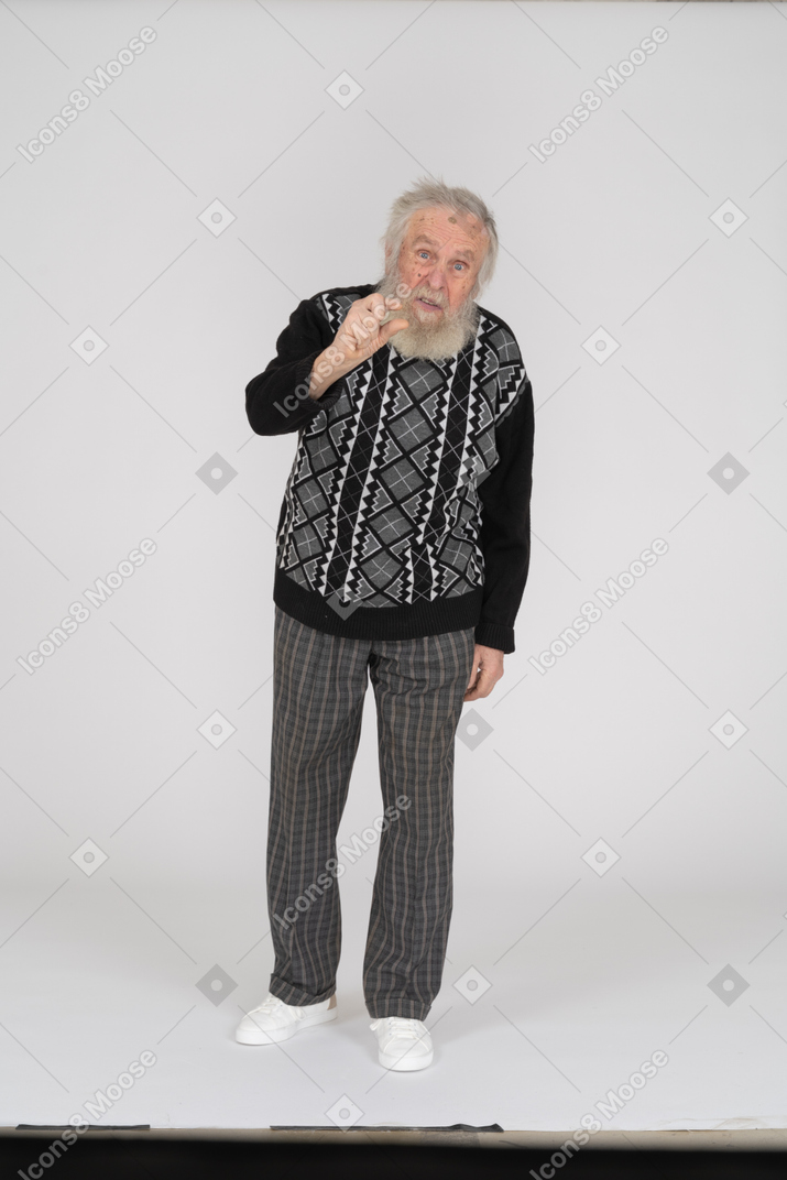 Old man showing small gesture with fingers