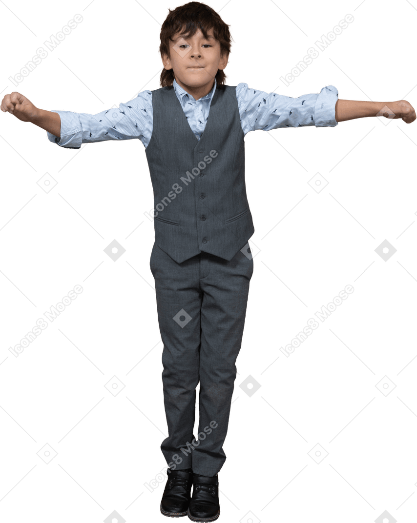 Front view of a boy in suit standing with outstretched arms