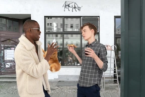 A man standing next to another man holding food