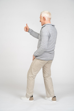 Side view of man giving thumbs up