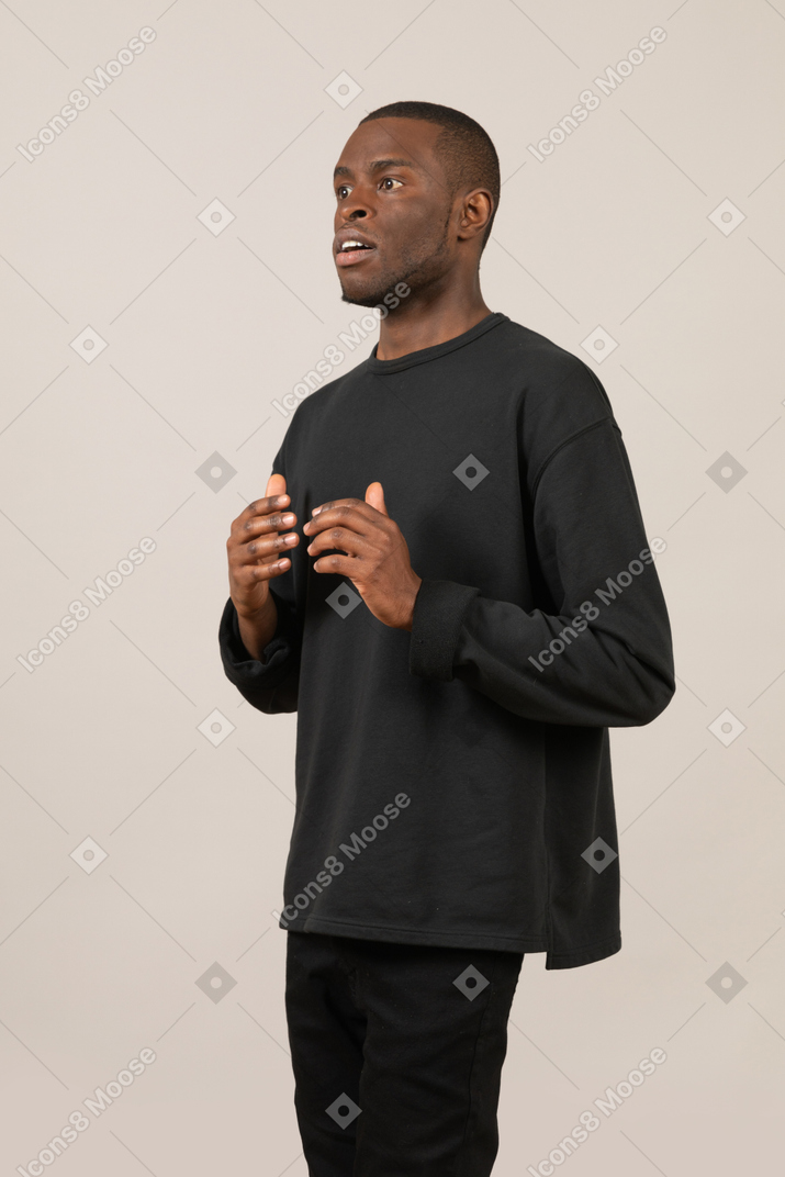Shocked young man in black outfit