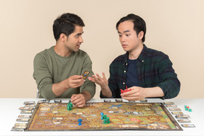 Amigos interraciales descubriendo algo mientras juegan juegos de mesa