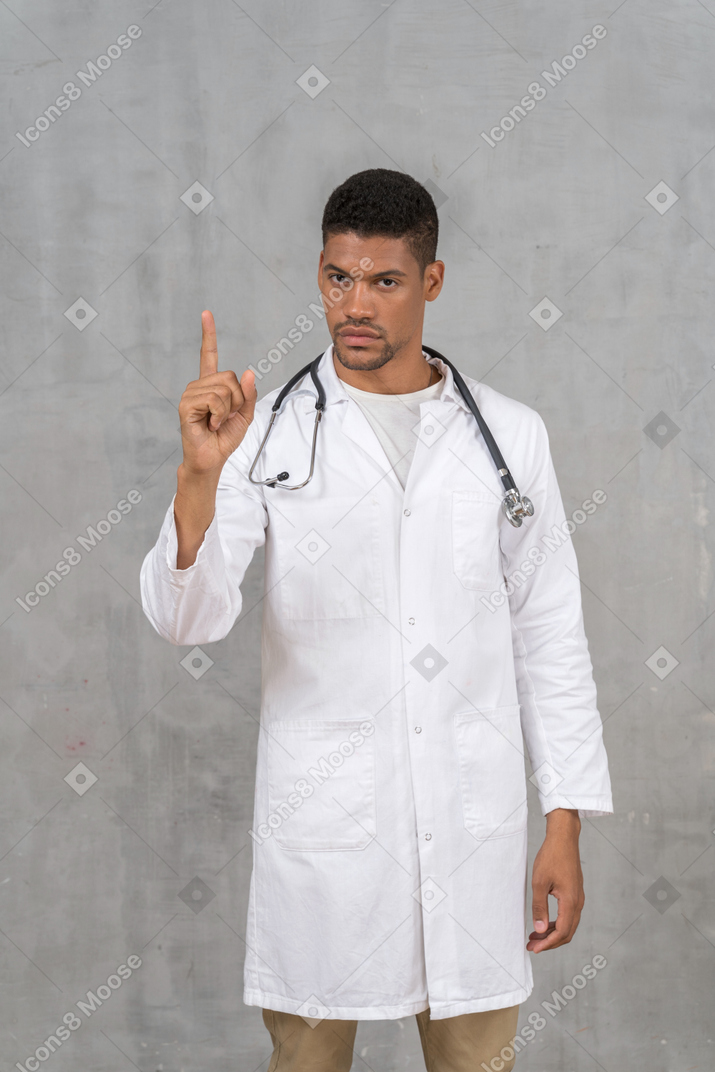 Disapproving male doctor shaking his finger